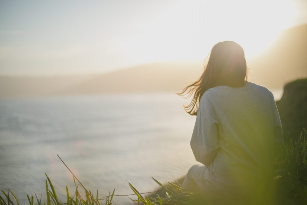 A woman looking out in the ocean