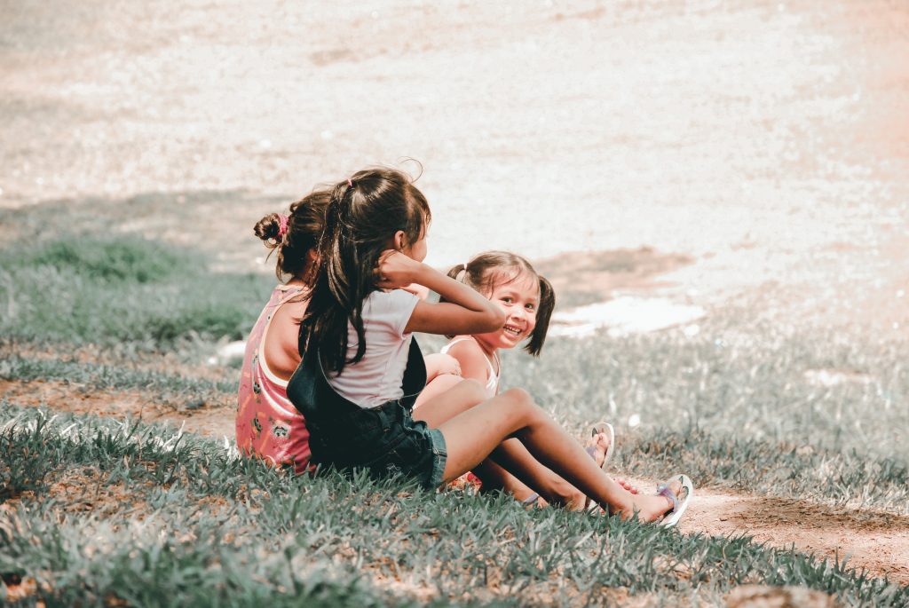 Young happy kids sitting on a hill