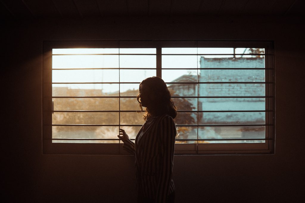 woman turning away from window