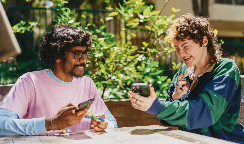 Young adults watching a smart phone