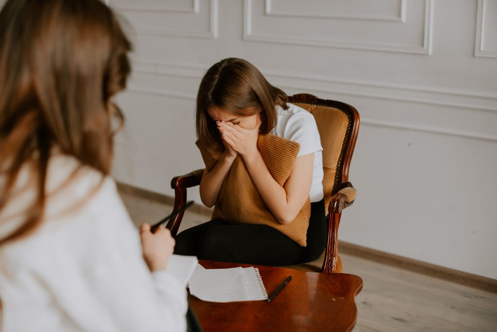 Young woman crying with a therapist