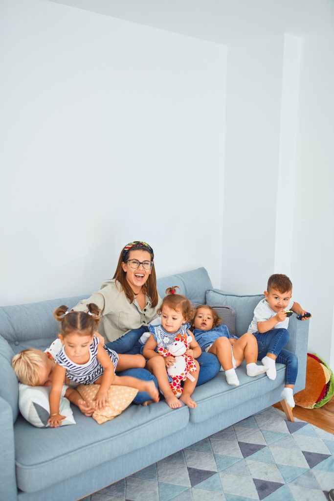 Woman with four young kids on a sofa