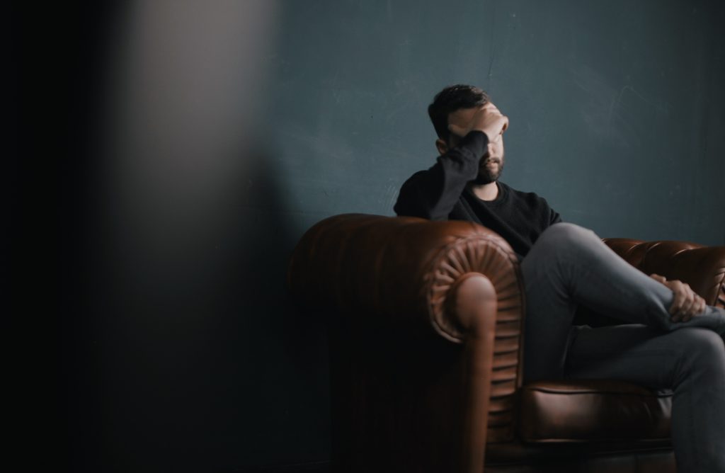 Man resting his head in his hands