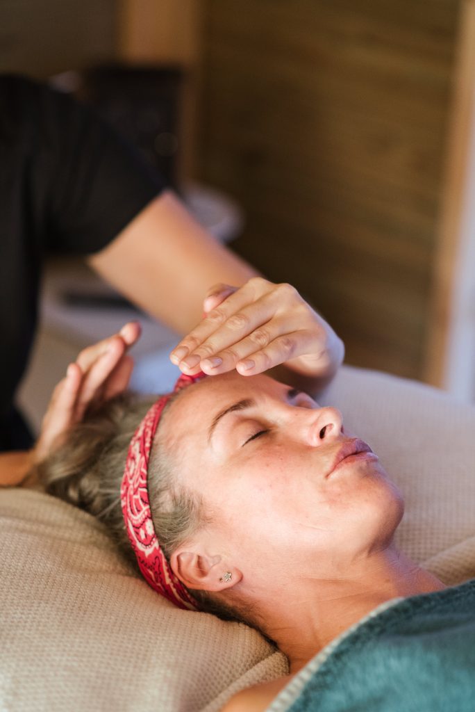 Woman receiving reiki healing