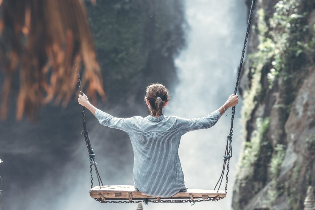 Woman on a large outdoor swing