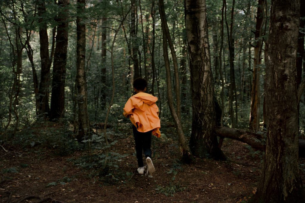 Boy running through woods