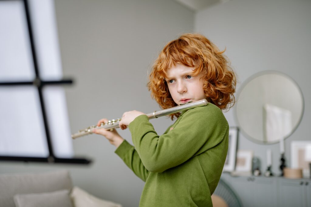 Young child playing the flute